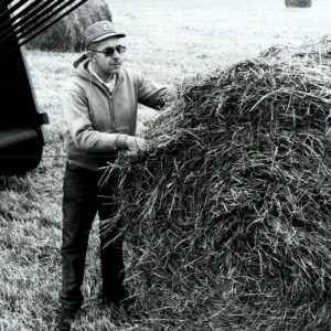November 2, 1971 Kenneth Ernst with a bale in a farm field
