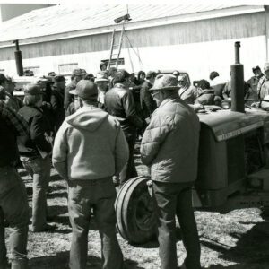 A group of men standing around equipment